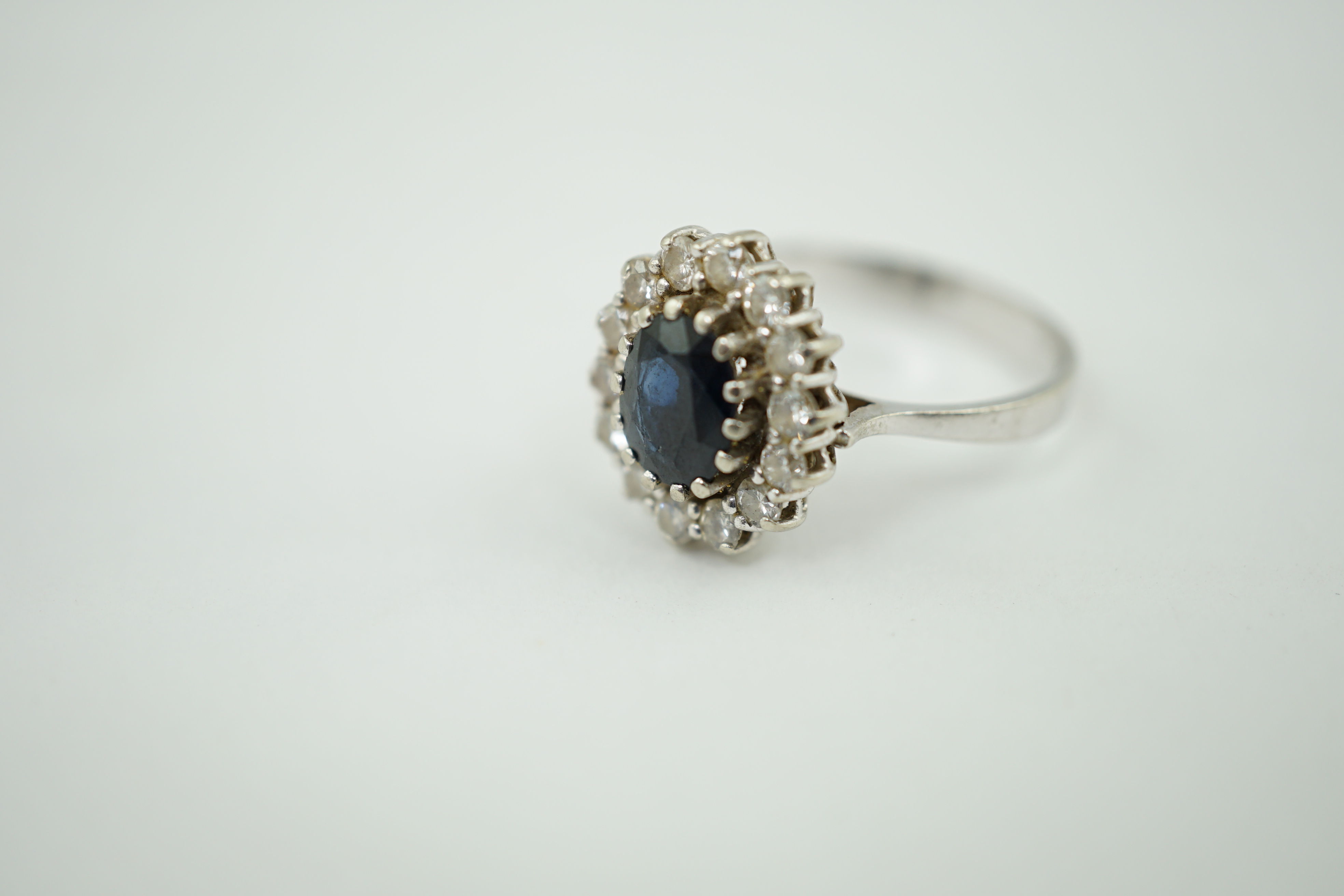 A mid to late 20th century 14k white gold, sapphire and diamond set oval cluster ring